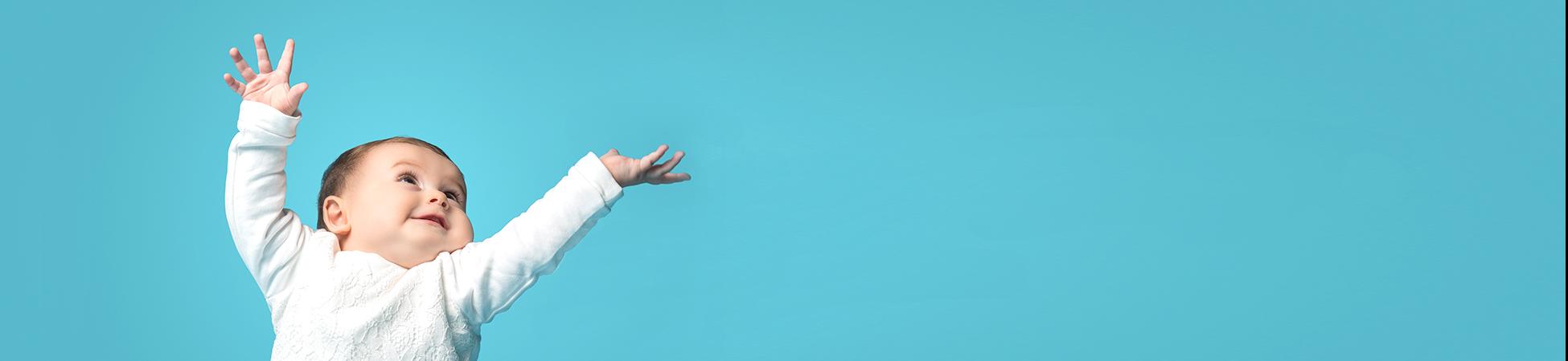 photo of a baby with arms up