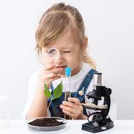 photo of a little girl playing with laboratory equipment